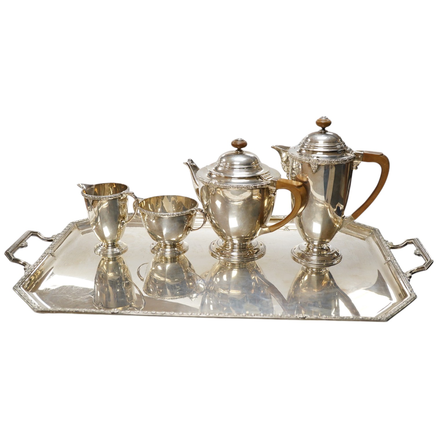 A George V silver five piece silver tea service including a two handled tea tray by Roberts & Belk, Sheffield, 1931/1934, tray 61.2cm over handles, gross weight 165.1oz. Condition - Fair to good